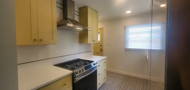 a kitchen with a stove and a refrigerator