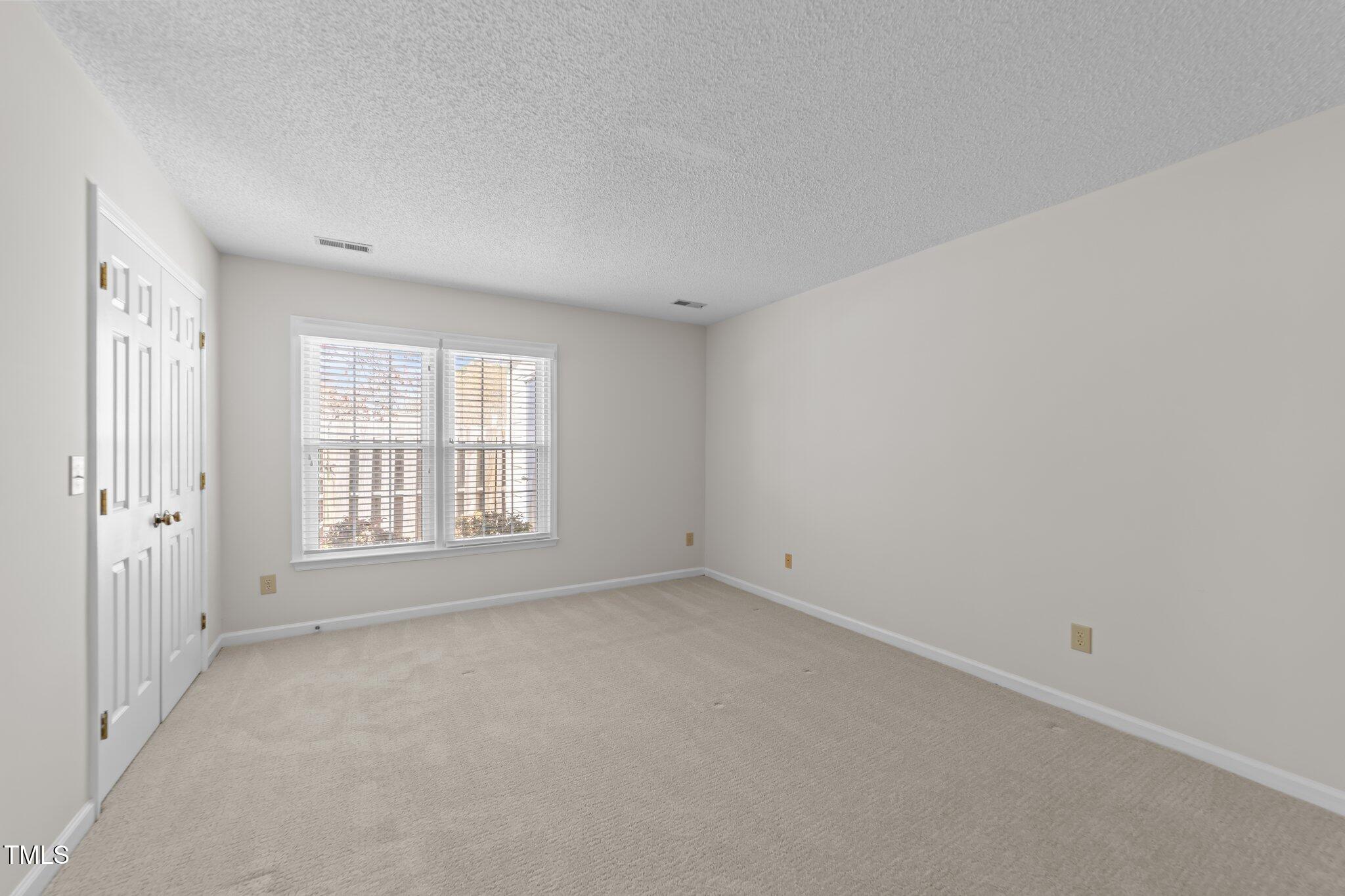 6817 Fairpoint Court Raleigh, NC 27613 - Photo 11 of 25 an empty room with a window