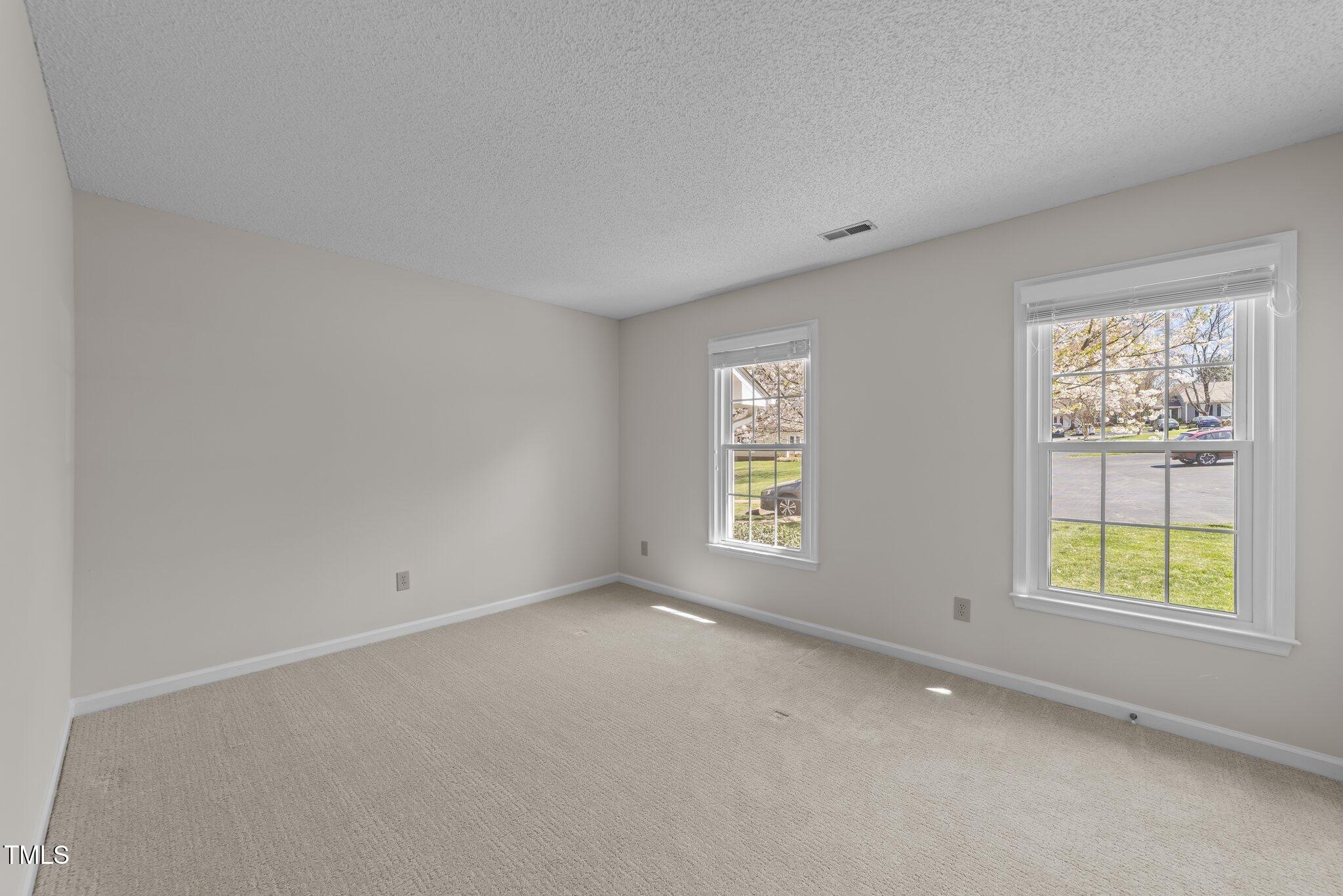 6817 Fairpoint Court Raleigh, NC 27613 - Photo 14 of 25 a view of an empty room with a window