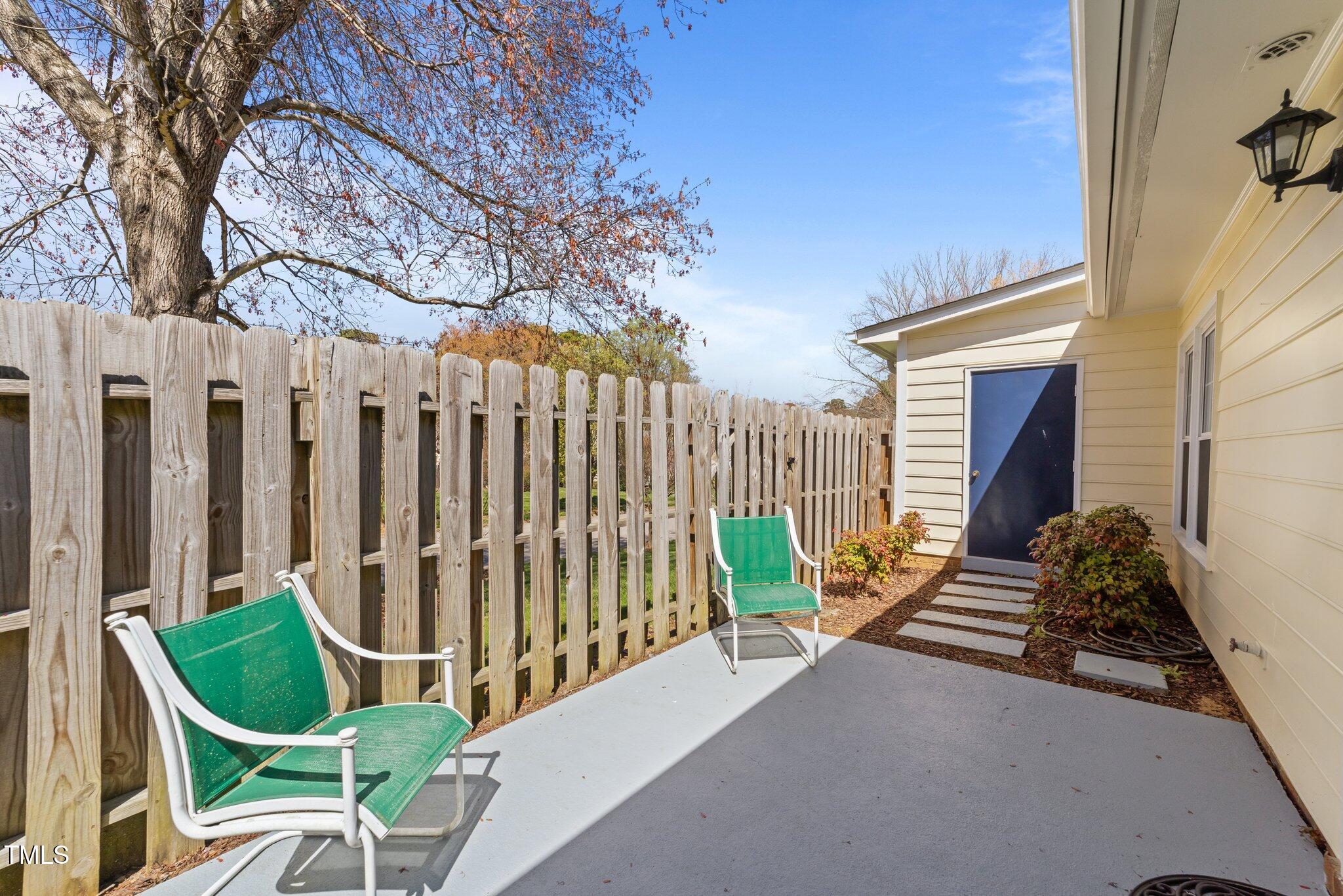 6817 Fairpoint Court Raleigh, NC 27613 - Photo 17 of 25 a backyard of a house with table and chairs