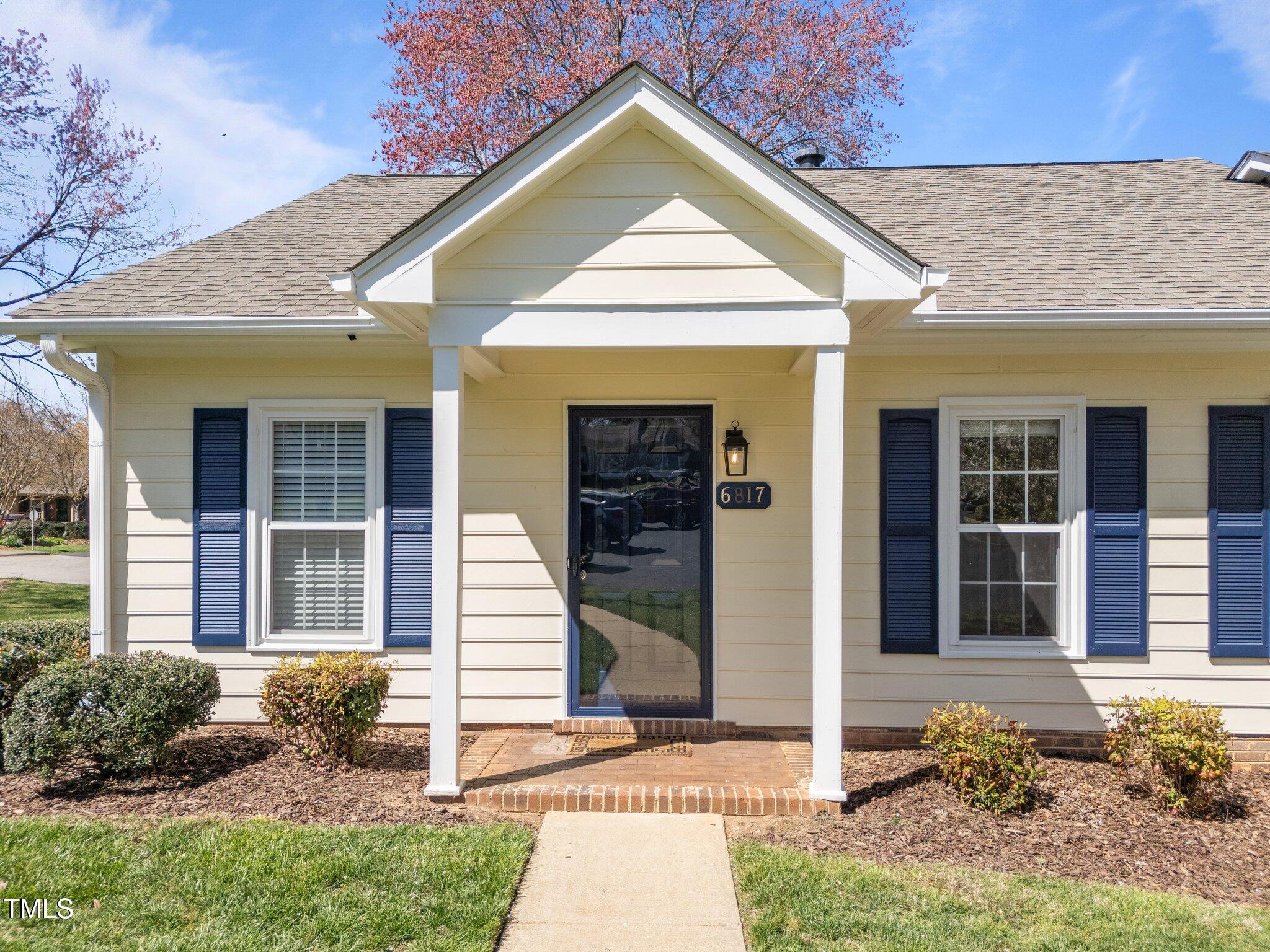 6817 Fairpoint Court Raleigh, NC 27613 - Photo 2 of 25 a view of a house with brick walls and a yard