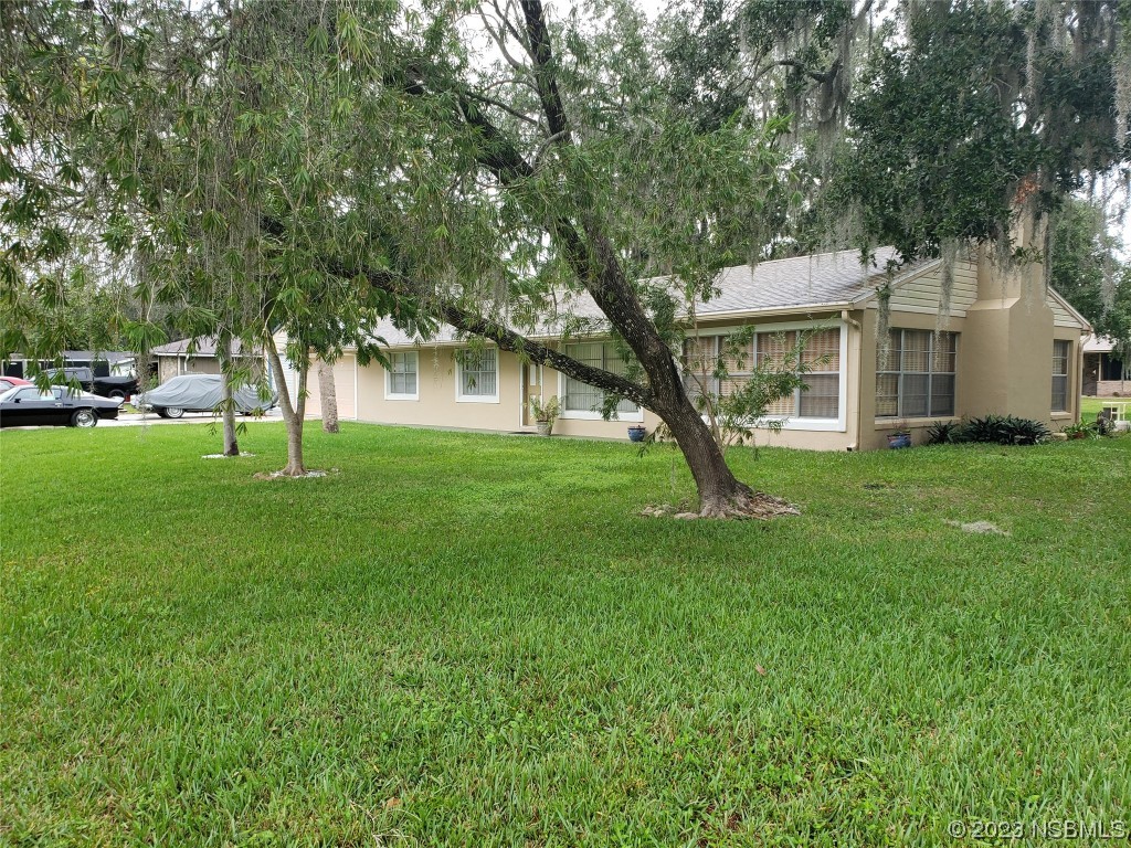 1867 Pine Tree Drive Edgewater, FL 32141 - Photo 3 of 21 a house view with a garden space