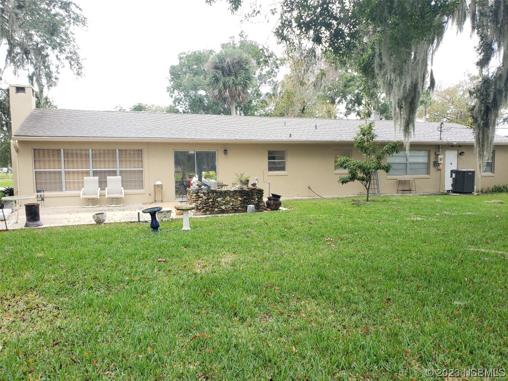 1867 Pine Tree Drive Edgewater, FL 32141 - Photo 4 of 21 a view of a backyard with table and chairs and potted plants