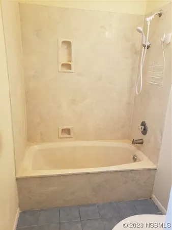 a bathroom with a bathtub and shower
