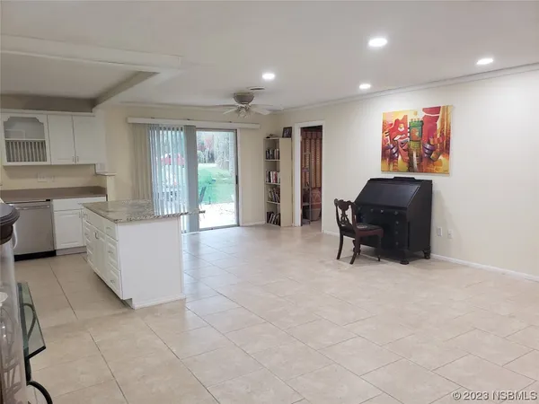 a living room with furniture and large windows
