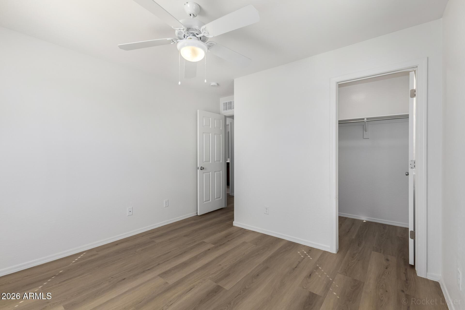 4084 East Ranch Road Gilbert, AZ 85296 - Photo 17 of 33 an empty room with wooden floor and ceiling fan