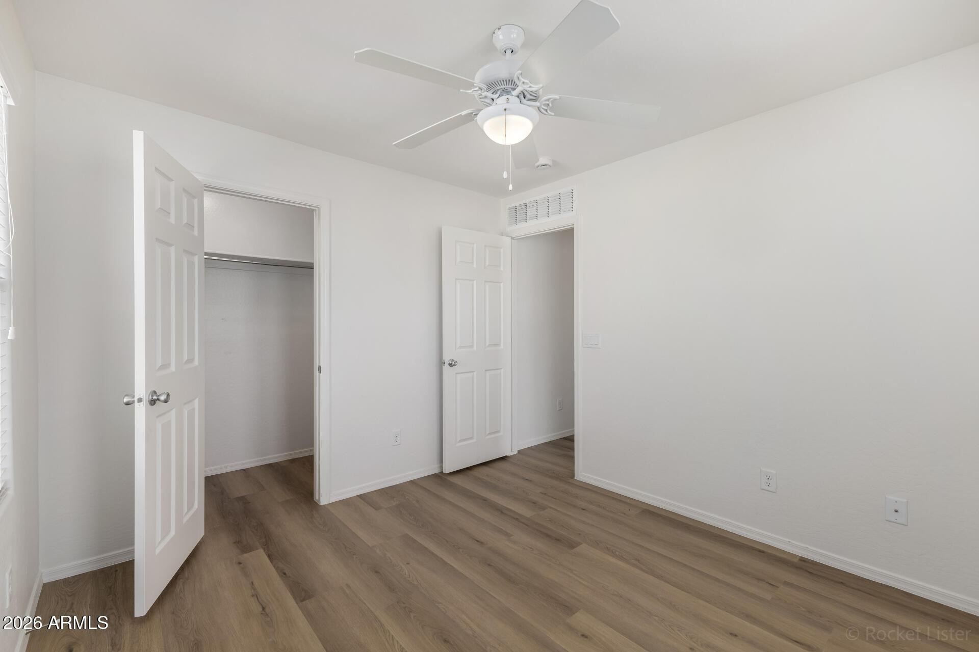 4084 East Ranch Road Gilbert, AZ 85296 - Photo 24 of 33 a view of a room with wooden floor and a ceiling fan
