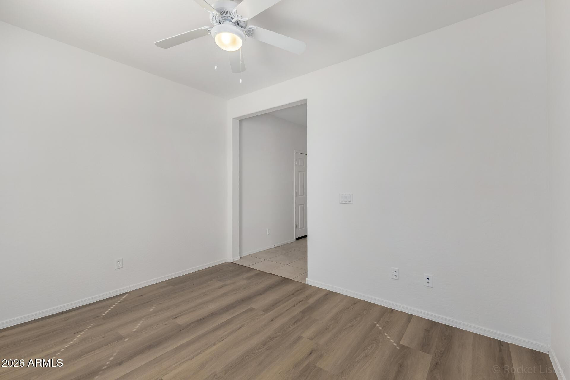 4084 East Ranch Road Gilbert, AZ 85296 - Photo 25 of 33 an empty room with wooden floor and fan