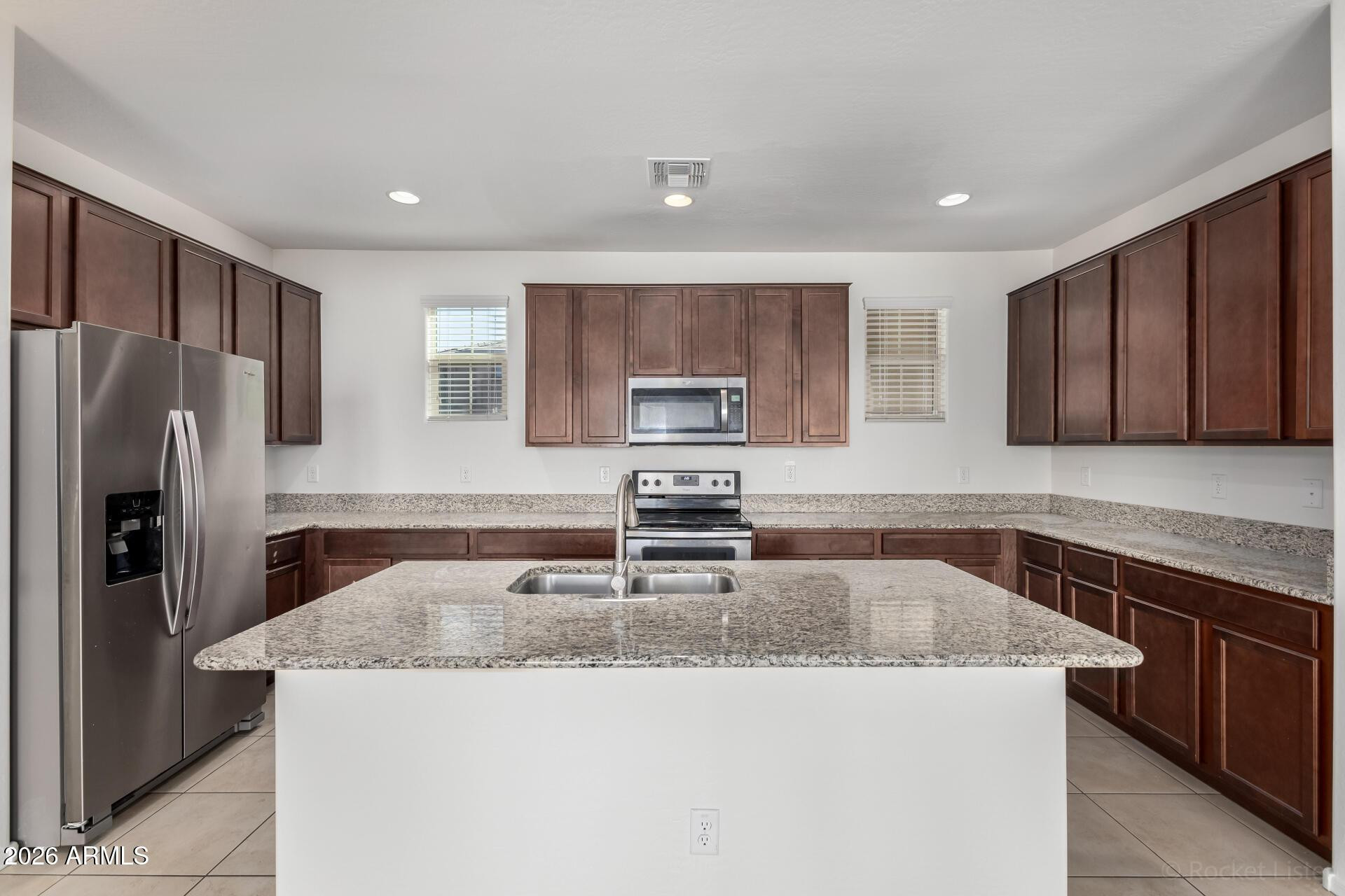 4084 East Ranch Road Gilbert, AZ 85296 - Photo 9 of 33 a kitchen with granite countertop a sink stove and refrigerator