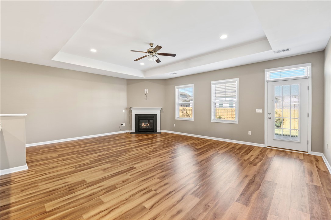 127 Spyglass Lane Pendleton, SC 29670 - Photo 22 of 45 Rich wood-textured flooring flows across a spacious layout anchored by a classic corner fireplace.