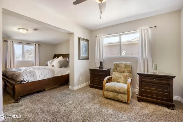 a living room with furniture ceiling fan and a window