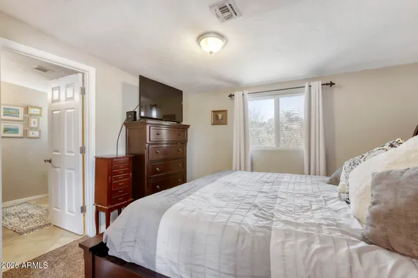 a bedroom with a bed and a window