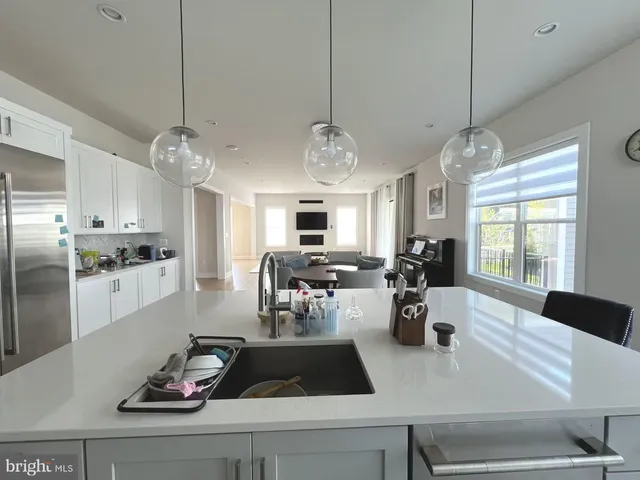 a large bathroom with a double vanity sink a large mirror and a bathtub