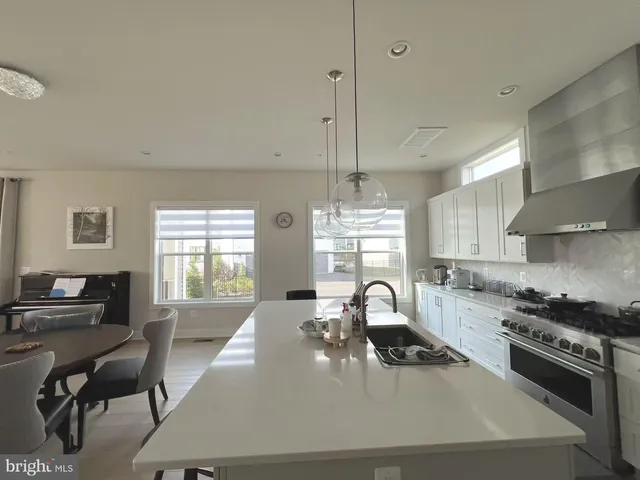 a spacious bathroom with a tub sink shower and mirror