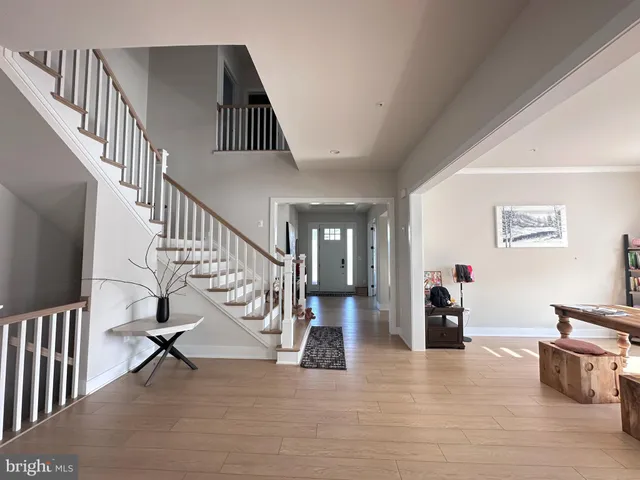 a spacious bathroom with a double vanity sink a mirror and a large window
