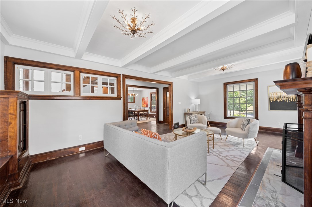 3139 Whitethorn Road Cleveland, OH 44118 - Photo 12 of 50 Living room featuring beam ceiling, dark wood-type flooring, and an inviting chandelier