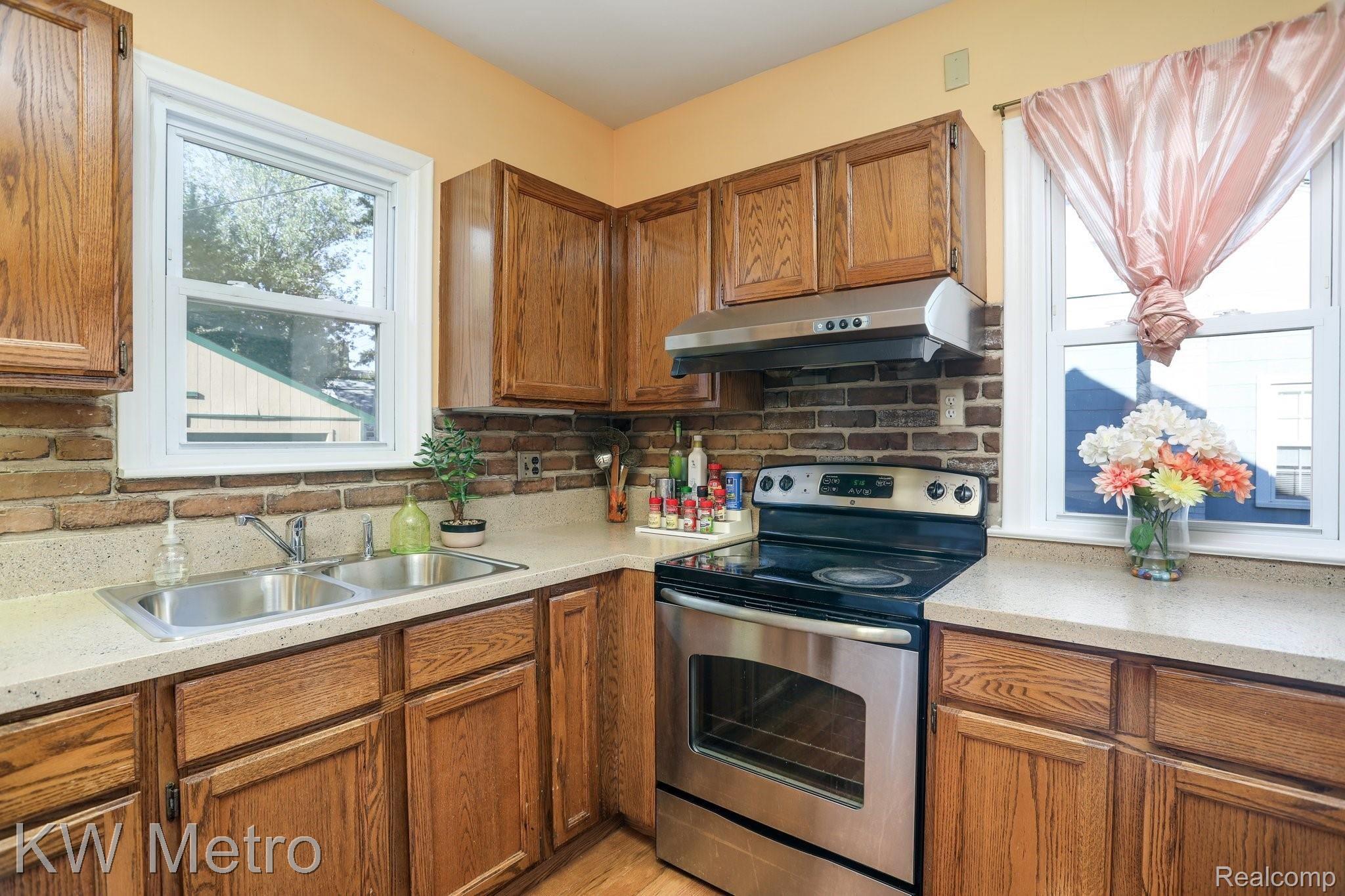 2428 Cambridge Road Berkley, MI 48072 - Photo 13 of 35 The kitchen offers trendy brick back splash.