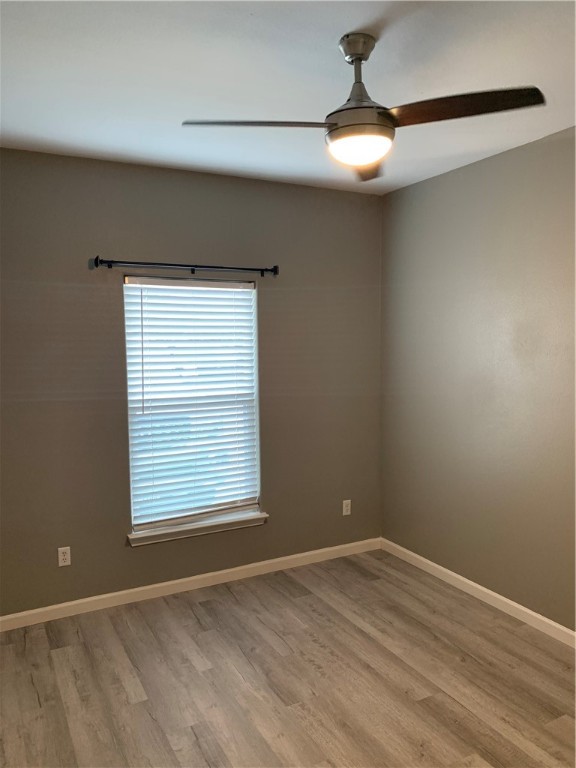 929 Moore Avenue Portland, TX 78374 - Photo 3 of 18 a view of an empty room with window and chandelier fan