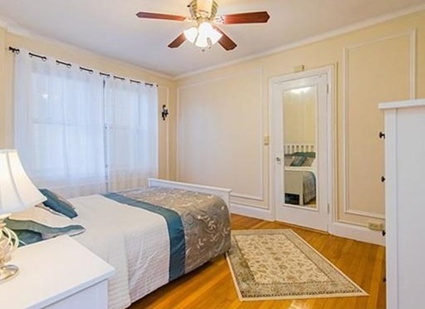 1450 Beacon Street, Unit 504 Brookline, MA 02446 - Photo 5 of 21 a spacious bedroom with a bed and a rug