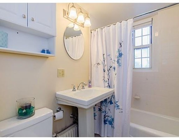 1450 Beacon Street, Unit 504 Brookline, MA 02446 - Photo 6 of 21 a bathroom with a sink a mirror and a shower