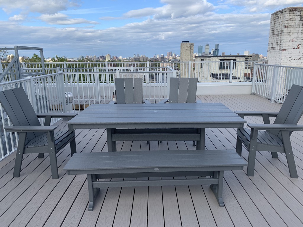 1450 Beacon Street, Unit 504 Brookline, MA 02446 - Photo 8 of 21 a view of a balcony with a table and chairs