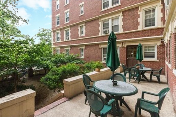 1450 Beacon Street, Unit 504 Brookline, MA 02446 - Photo 9 of 21 a view of a patio with table and chairs and potted plants