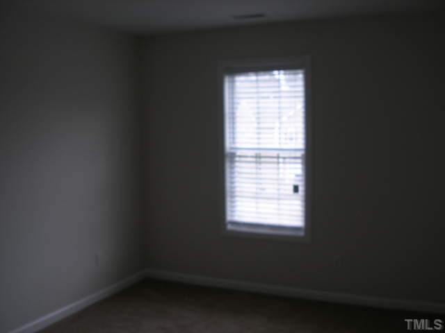 3633 Rendition Street Raleigh, NC 27610 - Photo 11 of 17 a view of an empty room with a window