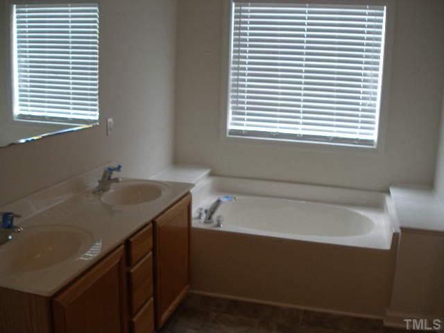 3633 Rendition Street Raleigh, NC 27610 - Photo 8 of 17 a bathroom with a sink and a bathtub