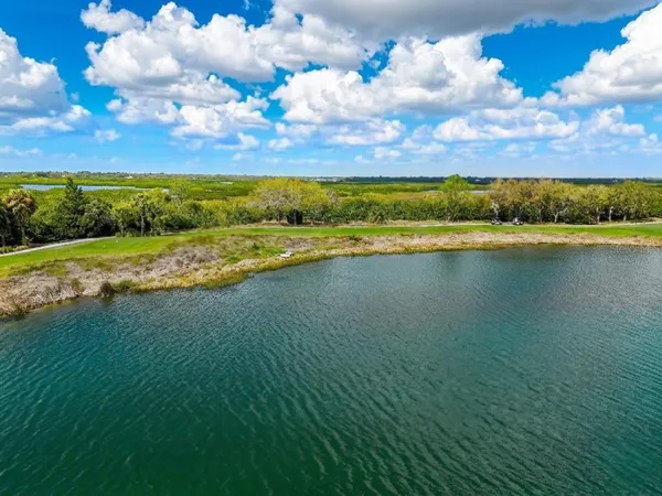 a view of a hallway and a livingroom with furniture