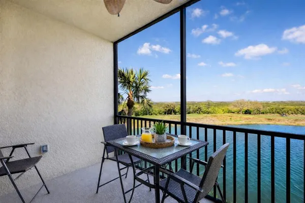 a view of a balcony with furniture and wooden floor