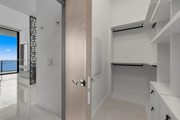 a bathroom with a shower and a glass door