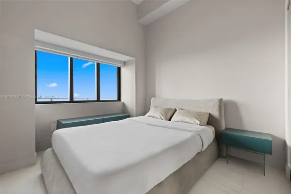 a bedroom with a bed and a window