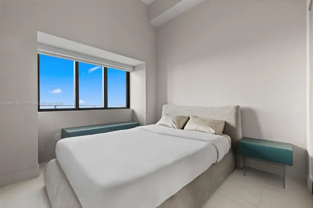 a bedroom with a bed and a window