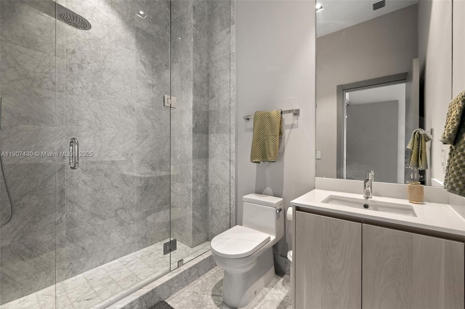 480 Northeast 31st Street, Unit PH5002 Miami, FL 33137 - Photo 15 of 15 a bathroom with a sink a toilet and shower