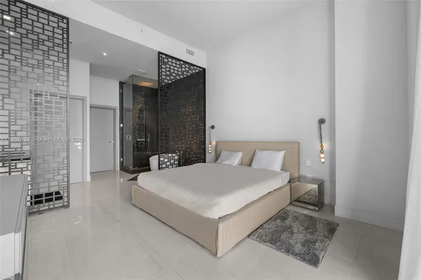 a spacious bedroom with a bed and a couch