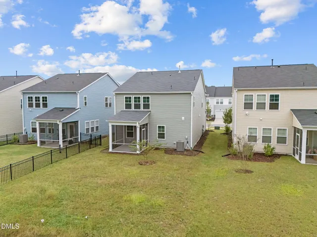 a view of a house with a big yard and large trees