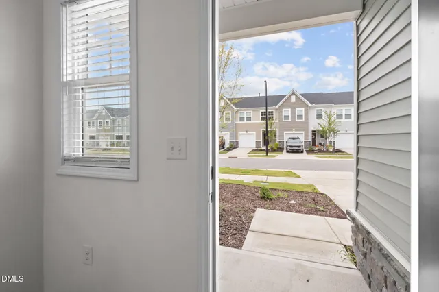 a view of a kitchen with sink and windows