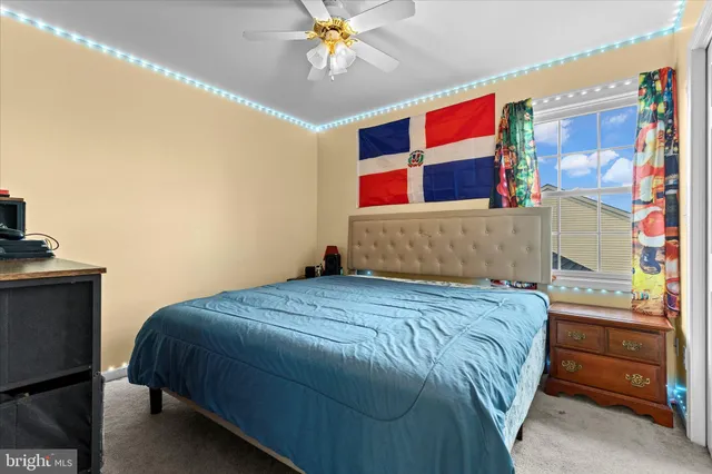 a bedroom with a bed and a painting on the wall