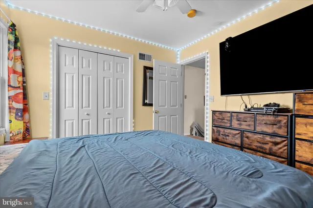 a bedroom with a bed and a flat screen tv