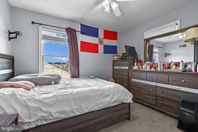 a bedroom with a bed and dresser