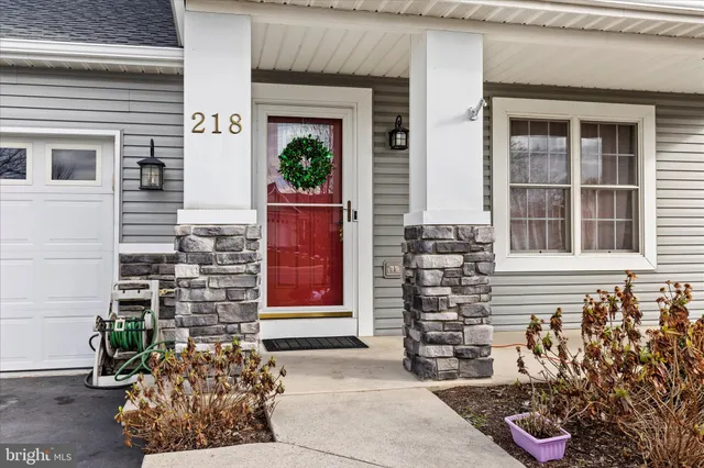 a front view of a house with a potted plant