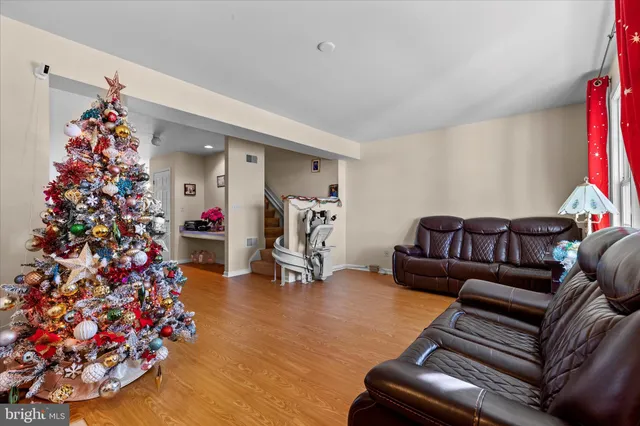 a living room with furniture and flowers