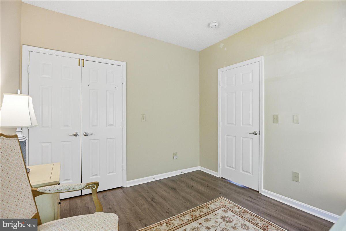1126 Back Creek Loop, Unit 1126 Solomons, MD 20688 - Photo 38 of 47 Bedroom 2 closet and door to hallway