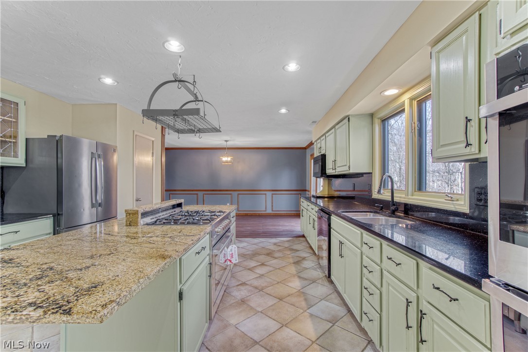 29329 Eddy Road Wickliffe, OH 44092 - Photo 11 of 50 Kitchen with light green cabinetry, granite countertops and a center island