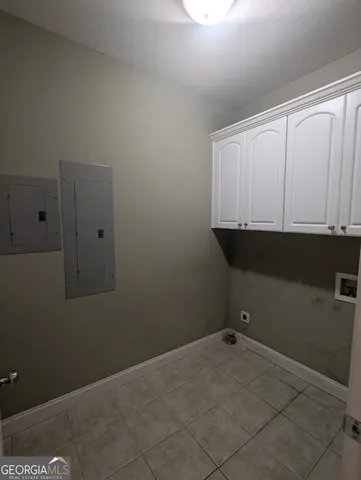 a view of a utility room with cabinets