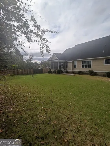 a view of residential houses with yard and lake view