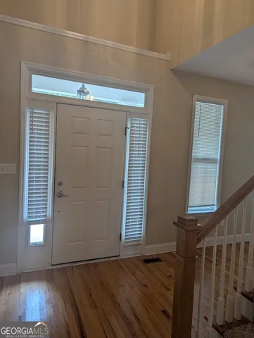 a view of front door with wooden floor
