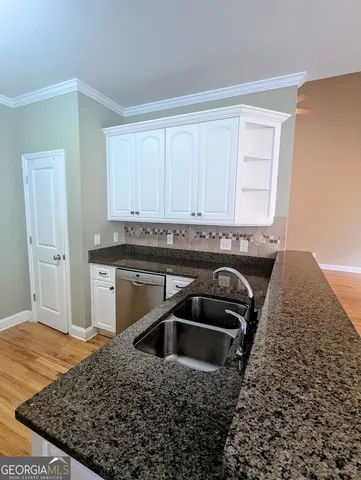 a kitchen with a sink stove and cabinets