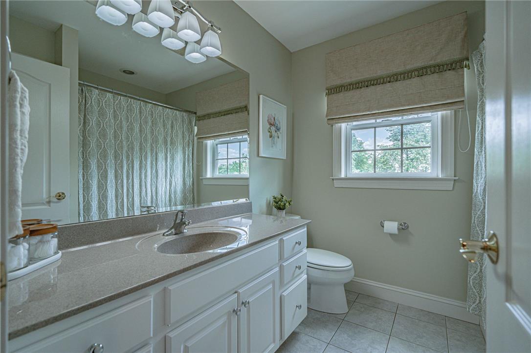 6000 Pond View Terrace Bath, PA 18014 - Photo 43 of 69 A well-lit bathroom with a spacious vanity and an oversized mirror, offering privacy with elegant window treatments.