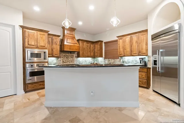 a kitchen with stainless steel appliances granite countertop a stove sink and cabinets